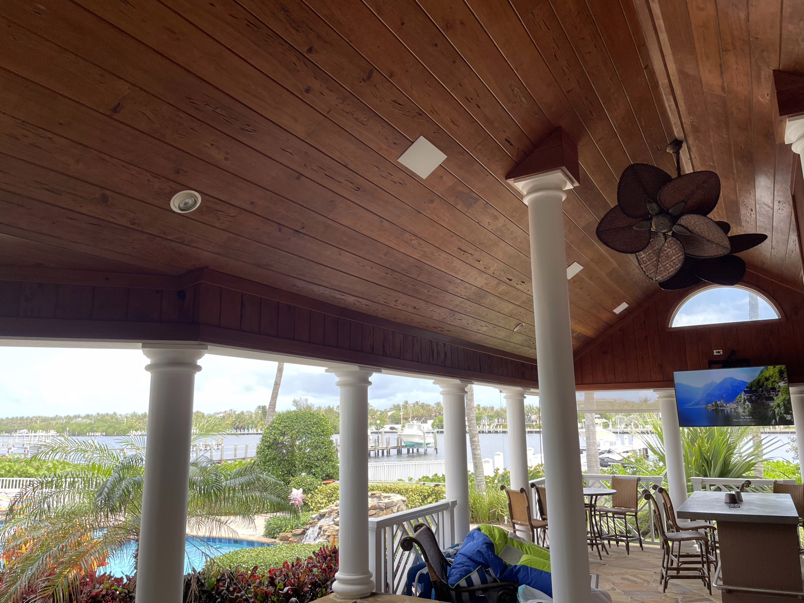Modern smart lanai in Boynton Beach featuring integrated outdoor lighting, automated screens, and weather-proof audio controlled by a Control4 system.