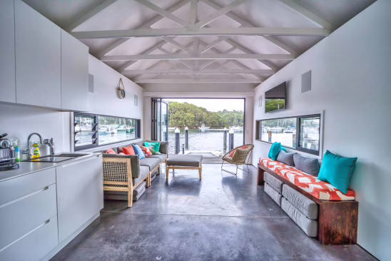 Modern luxury kitchen with high-end appliances and waterfront views in a Palm Beach Island smart home featuring integrated automation.