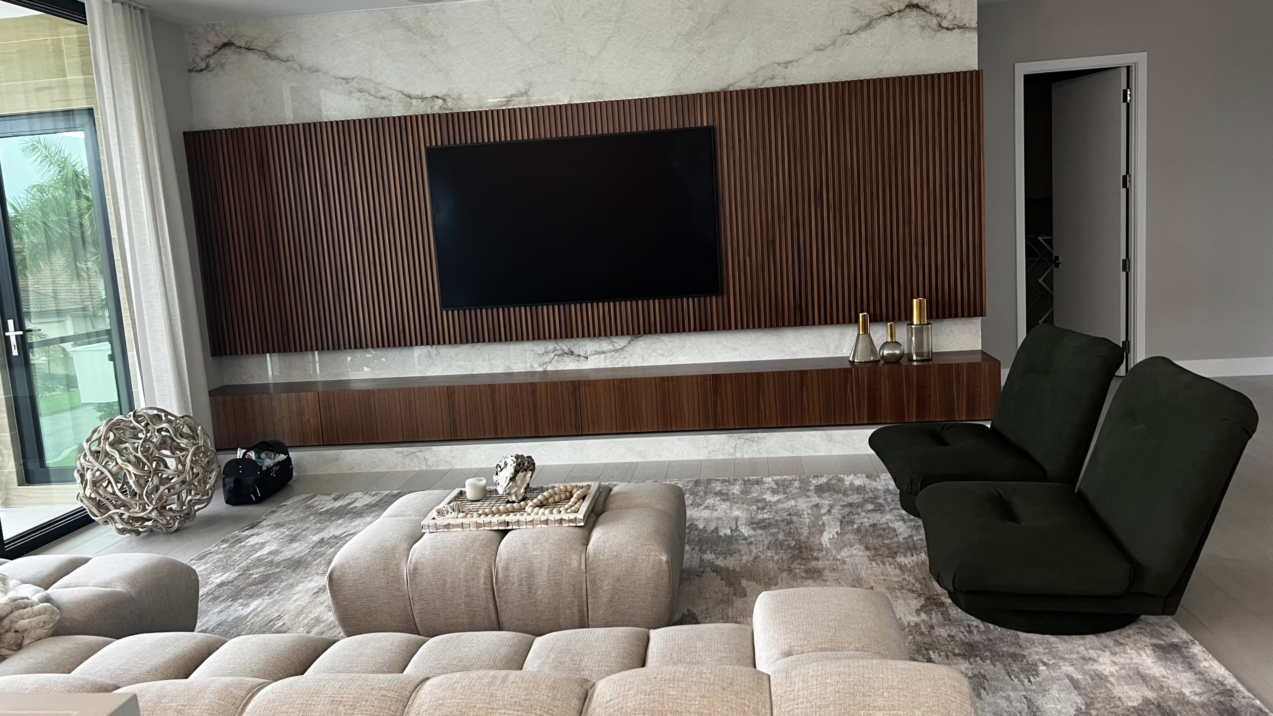 Elegant 85-inch Samsung smart TV integrated with high-performance in-ceiling surround sound and Control4 automation in a luxury Jupiter family room.