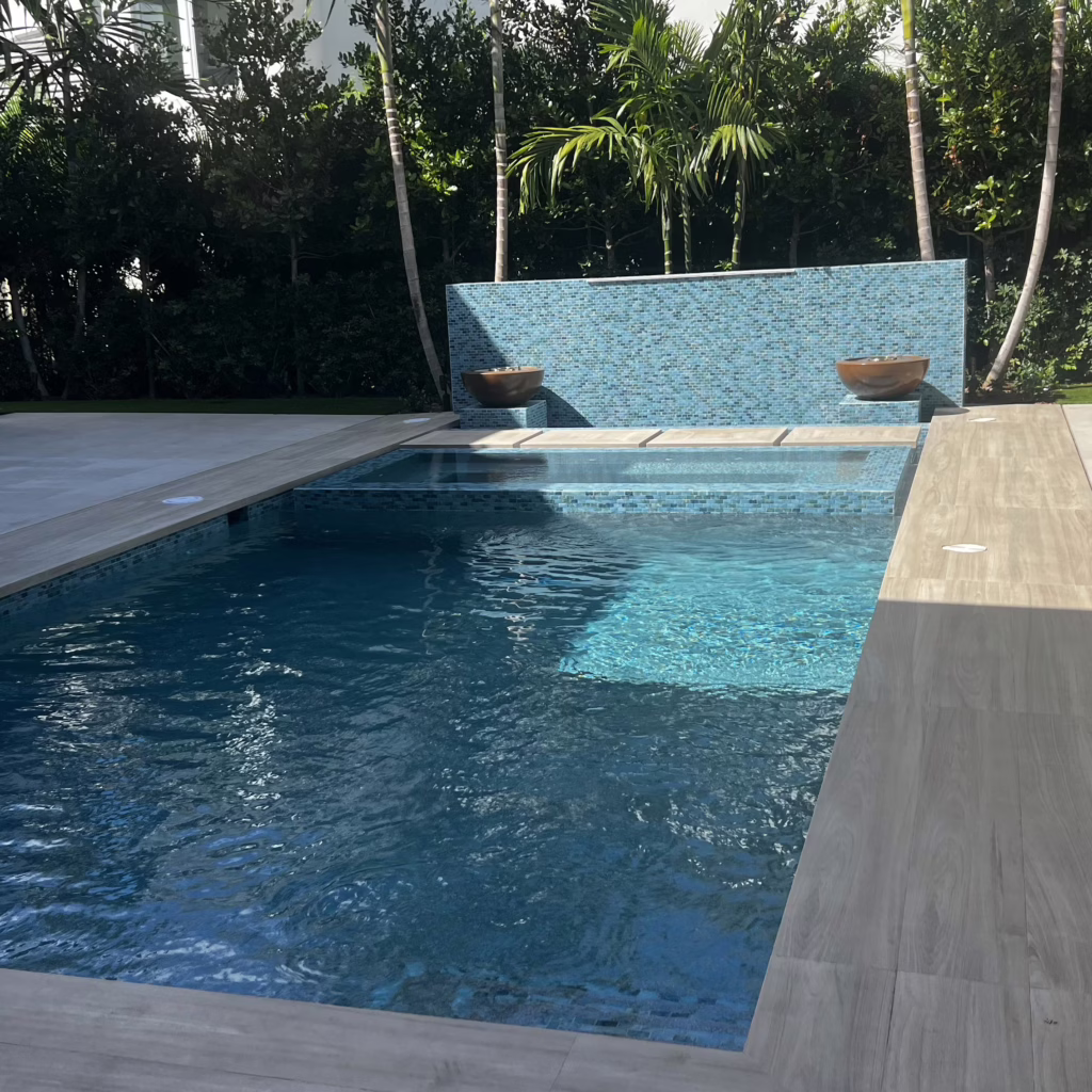 Luxury Jupiter outdoor audio installation featuring Triad Landscape speakers integrated with stone waterfall lighting.