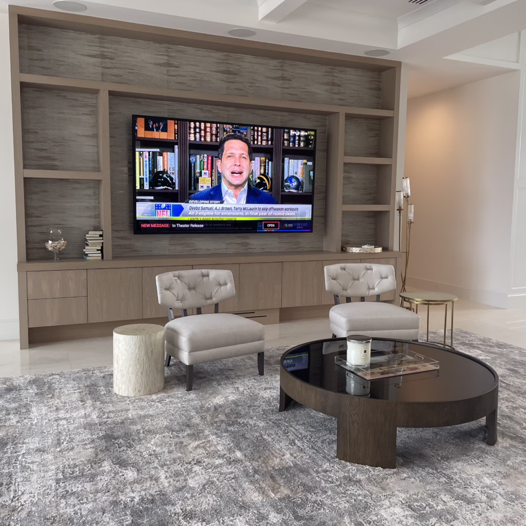Large 96-inch Samsung display integrated into a custom wooden wall unit with discrete in-ceiling surround sound speakers and Control4 smart home automation.